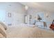 Bright bedroom with a high ceiling, neutral color palette, and a decorative chandelier above the bed at 111 Esther St, New Smyrna Beach, FL 32169