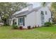 Charming stucco home featuring a manicured lawn, a chimney, and a window with shutters at 111 Esther St, New Smyrna Beach, FL 32169