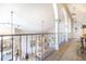 Hallway overlooking the main room features arched openings with decorative columns and a view of the elegant dining area at 111 Esther St, New Smyrna Beach, FL 32169