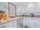 Bright kitchen features stainless steel appliances, granite countertops, and white cabinets at 111 Esther St, New Smyrna Beach, FL 32169
