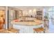 The kitchen showcases a round central island, modern stainless steel appliances, and stylish tile flooring at 111 Esther St, New Smyrna Beach, FL 32169