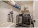 Convenient laundry room with modern washer and dryer, storage shelves, and ample space for organization at 111 Esther St, New Smyrna Beach, FL 32169