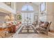 Bright living room boasts vaulted ceilings, plantation shutters, and a cozy fireplace at 111 Esther St, New Smyrna Beach, FL 32169