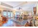 Cozy living room featuring hardwood floors, a tray ceiling, and natural light at 111 Esther St, New Smyrna Beach, FL 32169