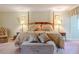 Bright main bedroom with a king bed, sitting area, and soft natural light creates a comfortable and inviting atmosphere at 111 Esther St, New Smyrna Beach, FL 32169