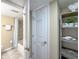 Bathroom view showing a tub and shower, toilet and shelving unit at 111 N Atlantic Ave # A219, New Smyrna Beach, FL 32169