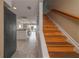 Hallway to the kitchen with wooden stairs and tile flooring at 111 N Atlantic Ave # A219, New Smyrna Beach, FL 32169