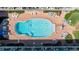 Aerial view of a large pool surrounded by lounge chairs and manicured landscaping at 111 N Atlantic Ave # A219, New Smyrna Beach, FL 32169