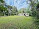 Backyard view of a home with a large yard and storage shed at 1136 Elizabeth St, New Smyrna Beach, FL 32168