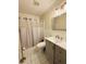A charming bathroom with shower-tub combo, updated vanity, and neutral paint palette at 1136 Elizabeth St, New Smyrna Beach, FL 32168
