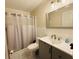 A charming bathroom with shower-tub combo, updated vanity, and neutral paint palette at 1136 Elizabeth St, New Smyrna Beach, FL 32168