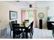 Bright dining room featuring tile flooring, modern lighting, and sliding doors to the backyard at 1136 Elizabeth St, New Smyrna Beach, FL 32168