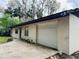 Charming single-story home featuring a one-car garage and colorful flower decorations at 1136 Elizabeth St, New Smyrna Beach, FL 32168