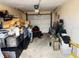 Cluttered garage space with a lawnmower and various storage containers at 1136 Elizabeth St, New Smyrna Beach, FL 32168