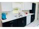 Well-lit kitchen area with stainless steel sink, modern white countertops and cabinetry at 1136 Elizabeth St, New Smyrna Beach, FL 32168