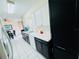 Modern kitchen features updated white and black cabinetry, providing a stylish and functional space at 1136 Elizabeth St, New Smyrna Beach, FL 32168