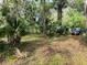 Land with mature trees, native palms, a black SUV, and natural vegetation at 1136 Elizabeth St, New Smyrna Beach, FL 32168