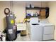 Laundry room featuring a washing machine, dryer, sink, and water heater at 1136 Elizabeth St, New Smyrna Beach, FL 32168