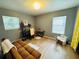 Inviting living room with wood floors, futon, and windows with blinds at 1136 Elizabeth St, New Smyrna Beach, FL 32168
