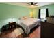 A spacious main bedroom featuring a ceiling fan and hardwood floors at 1136 Elizabeth St, New Smyrna Beach, FL 32168
