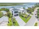 Aerial view of waterfront property with modern home, well-kept lawn, and surrounding scenery at 1194 N Peninsula, New Smyrna Beach, FL 32169