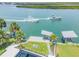 Waterfront property featuring a private dock, boat lifts, lush landscaping, and a stunning pool with amazing water access at 1194 N Peninsula, New Smyrna Beach, FL 32169