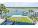 Waterfront backyard featuring a private dock, fire pit, and stunning pool with mosaic tile at 1194 N Peninsula, New Smyrna Beach, FL 32169