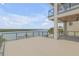 Spacious deck with glass railings offering panoramic water views, perfect for outdoor entertaining at 1194 N Peninsula, New Smyrna Beach, FL 32169