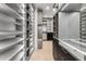 Expansive walk-in closet with custom shelving, drawers, and ample storage space at 1194 N Peninsula, New Smyrna Beach, FL 32169