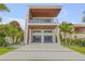 Modern home showcasing an extra long driveway leading to a contemporary residence with unique architectural details at 1194 N Peninsula, New Smyrna Beach, FL 32169