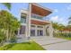 Striking modern home with a clean, white facade, covered balconies, and lush landscaping at 1194 N Peninsula, New Smyrna Beach, FL 32169