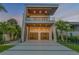 Contemporary exterior featuring clean lines, covered balconies, and a well-manicured lawn at 1194 N Peninsula, New Smyrna Beach, FL 32169