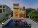 Stunning three-story modern home with a luxurious pool and elegant outdoor lounge area at 1194 N Peninsula, New Smyrna Beach, FL 32169