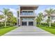 Stunning two-story modern home with a spacious driveway and lush tropical landscaping at 1194 N Peninsula, New Smyrna Beach, FL 32169