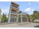 Impressive home with a sleek design, multiple balconies, and outdoor living space, surrounded by palm trees at 1194 N Peninsula, New Smyrna Beach, FL 32169