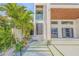 Contemporary home featuring a striking front entrance with unique walkway design and stylish landscaping at 1194 N Peninsula, New Smyrna Beach, FL 32169