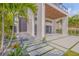 Contemporary home featuring a stylish entrance with a stone pathway and modern landscaping at 1194 N Peninsula, New Smyrna Beach, FL 32169