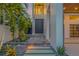 Contemporary home featuring a striking front entrance, complemented by lush tropical landscaping at 1194 N Peninsula, New Smyrna Beach, FL 32169