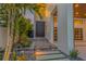 Beautifully landscaped front entrance with modern lighting and a sleek, dark front door at 1194 N Peninsula, New Smyrna Beach, FL 32169