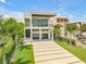 Striking contemporary home with a modern driveway, well-manicured lawn, and lush landscaping at 1194 N Peninsula, New Smyrna Beach, FL 32169
