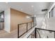 Hallway with glass railing, modern lighting fixtures, and hardwood flooring at 1194 N Peninsula, New Smyrna Beach, FL 32169