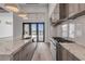 Modern kitchen with marble countertops and backsplash and stainless steel appliances overlooking the water at 1194 N Peninsula, New Smyrna Beach, FL 32169
