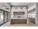 Modern kitchen with marble countertops, island, stainless steel appliances, and stylish lighting at 1194 N Peninsula, New Smyrna Beach, FL 32169