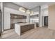 This modern kitchen features white and wood cabinets, marble counters and backsplash, and pendant lighting at 1194 N Peninsula, New Smyrna Beach, FL 32169