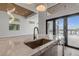 Bright kitchen featuring marble counters, a stainless steel sink, and a beautiful view of the water at 1194 N Peninsula, New Smyrna Beach, FL 32169