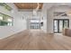 Bright and airy living room with a modern chandelier and light wood floors overlooking the water at 1194 N Peninsula, New Smyrna Beach, FL 32169