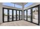 Bright living room featuring large windows and doors with views of the backyard pool and waterfront at 1194 N Peninsula, New Smyrna Beach, FL 32169