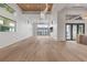 Spacious, bright living room with floor-to-ceiling windows and a stylish contemporary chandelier at 1194 N Peninsula, New Smyrna Beach, FL 32169