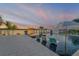 Beautiful waterfront pool area with lounge chairs, cabana, and serene sunset views at 1194 N Peninsula, New Smyrna Beach, FL 32169