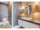 Chic powder room featuring unique wallpaper, a modern vanity, and stylish lighting fixtures at 1194 N Peninsula, New Smyrna Beach, FL 32169